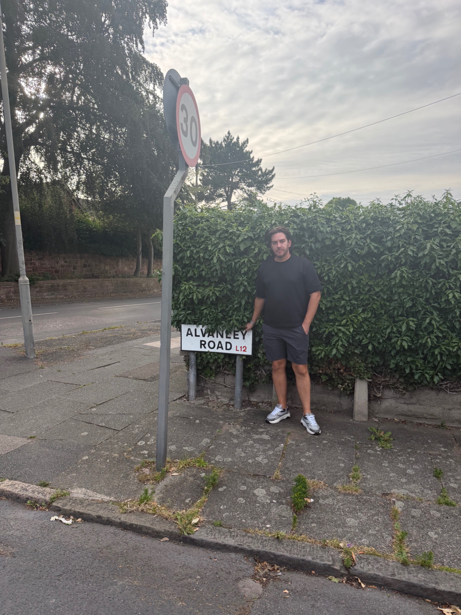 David Brookes-Lennon beside the Alvanley Road street sign